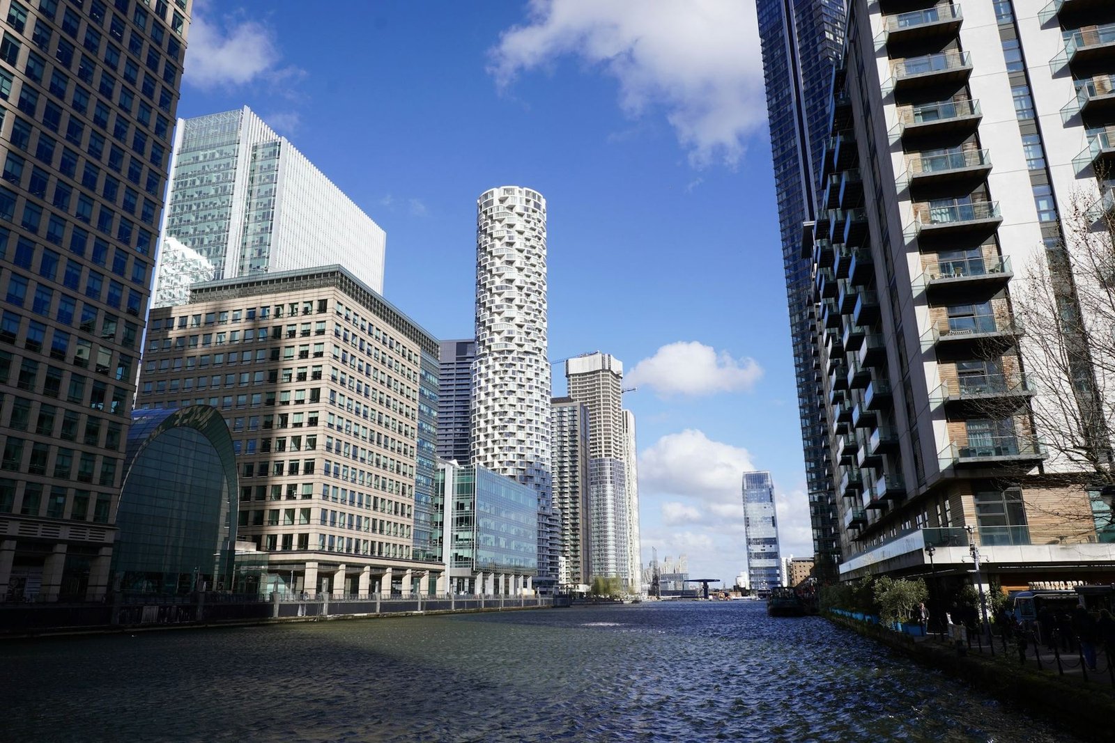 The towers of Canary Wharf in London rising above the water of the docks