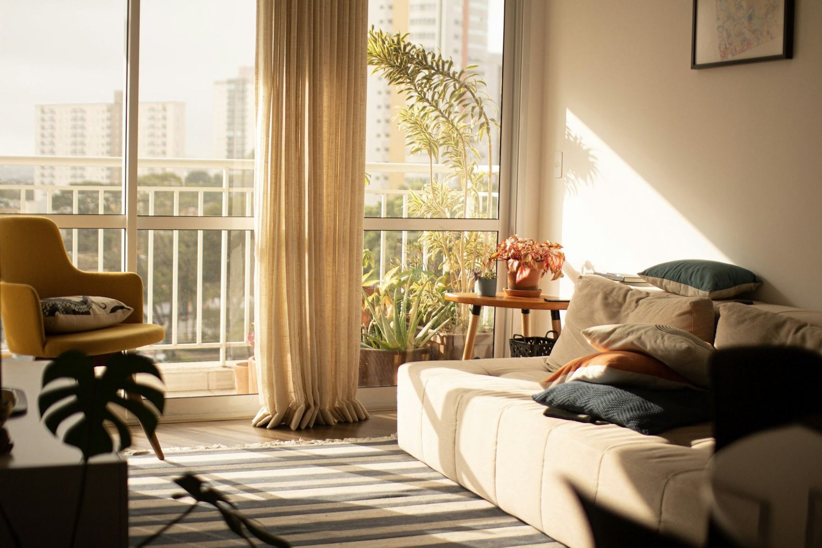 A bright modern living room with large windows in the morning light